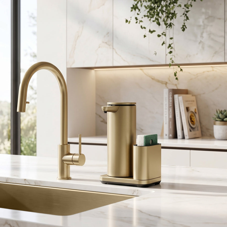 Simplehuman's 14 oz. Liquid Sensor Pump with Caddy in Matte Gold in a modern kitchen setting with marble countertops, backsplash, and cabinets.