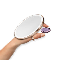 sensor mirror compact 10x - rose gold finish - hand holding makeup image